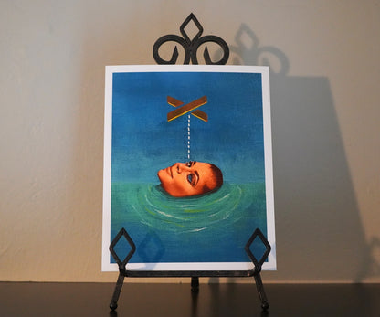 Artistic depiction of a head floating in water with an X above it on a blue background, displayed on an easel.
