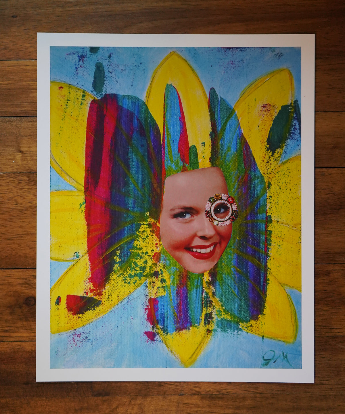 Colorful artwork of a face with a flower head on a wooden surface
