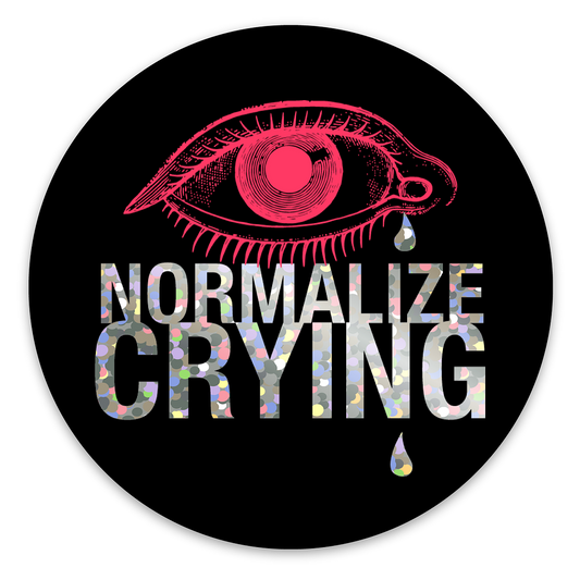 Circular sticker with pink eye illustration and 'Normalize Crying' text on a black background