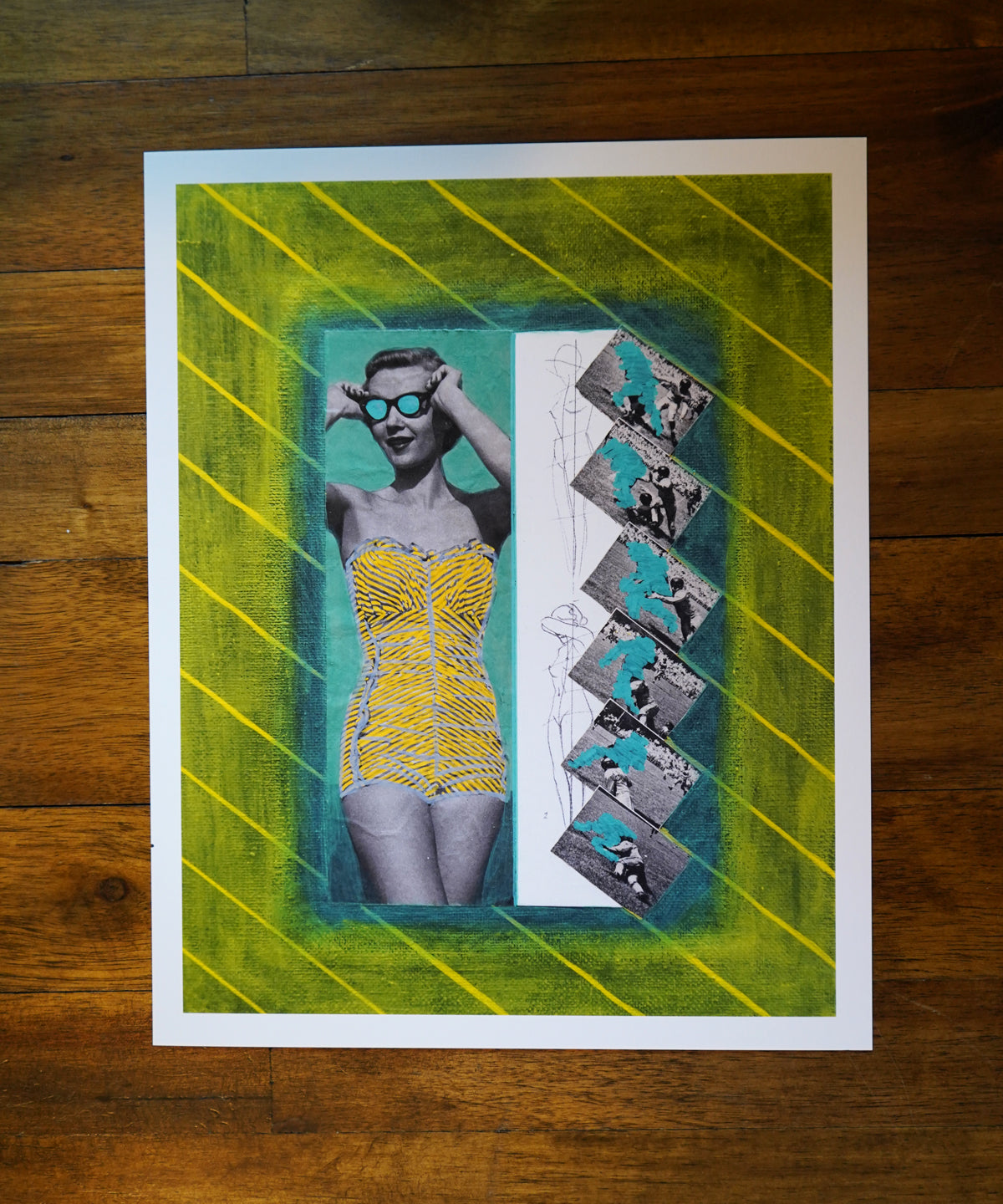 Artistic print of a woman in a yellow dress with geometric design on a wooden surface